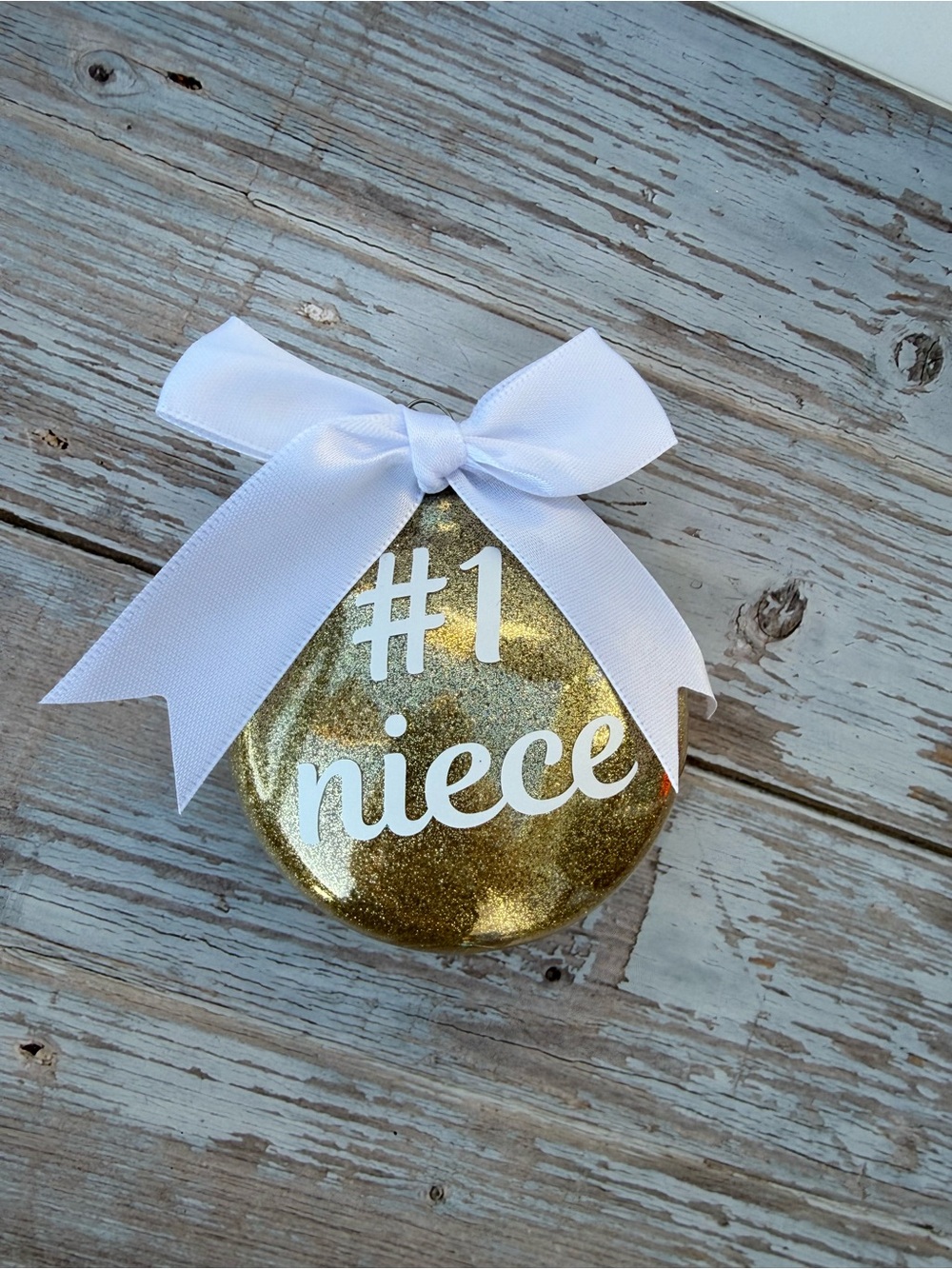 #1 Niece Gold Glitter Ornament with White Bow, disc ornament